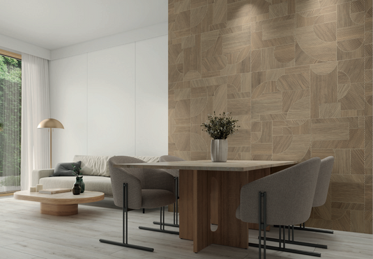 Modern living room with a geometric-patterned wall, wooden furniture, and a vase with flowers.